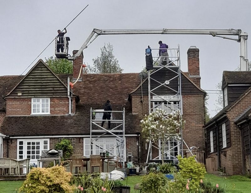 The Roof Moss Cleaners using cherry picker and scaffolding to clean roof safely and professionally in Kenilworth, Warwickshire